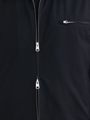 Next - Chaqueta de entretiempo 'Motionflex' en negro