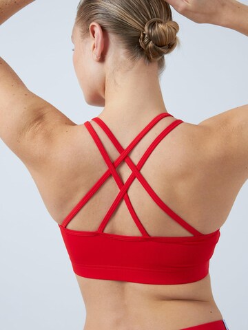 SPORTKIND Medium support Sport bh 'Crossed Straps' in Rood