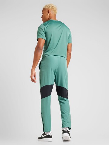 Loosefit Pantaloni sport 'Advantage' de la NIKE pe verde