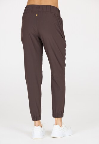 Athlecia Tapered Sports trousers 'Austberg' in Brown