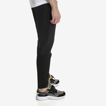 PUMA Zwężany krój Spodnie sportowe 'Evostripe Move' w kolorze czarny