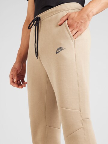 Nike Sportswear Tapered Housut 'Tech Fleece' värissä beige