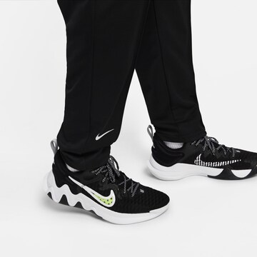 NIKE Zwężany krój Spodnie sportowe w kolorze niebieski