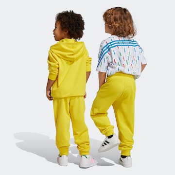 ADIDAS SPORTSWEAR Tapered Workout Pants 'LEGO' in Yellow