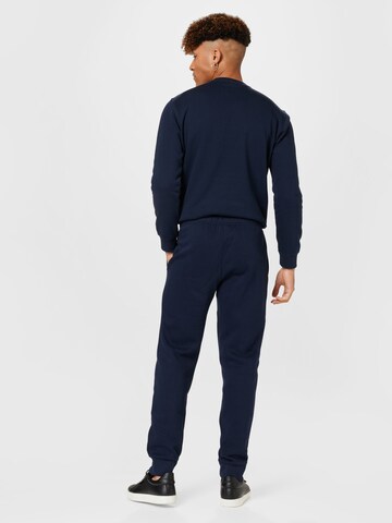 Champion Authentic Athletic Apparel Tapered Broek in Blauw