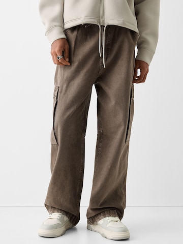 Bershka Loose fit Cargo trousers in Brown: front