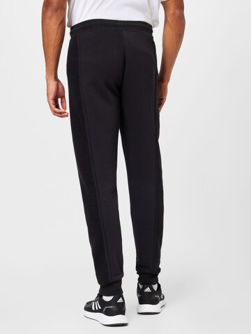 ADIDAS ORIGINALS Tapered Trousers 'Trefoil Essentials+ Reverse Material' in Black