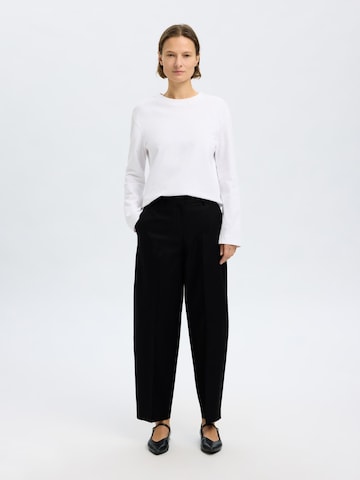 Loosefit Pantaloni con piega frontale di SELECTED in nero