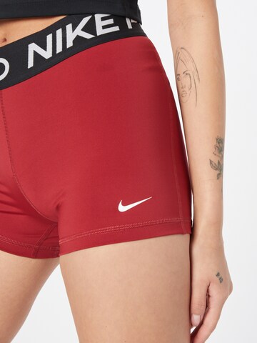 NIKE Skinny Urheiluhousut 'Pro' värissä punainen