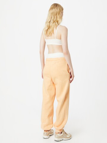 Tapered Pantaloni di Urban Classics in arancione