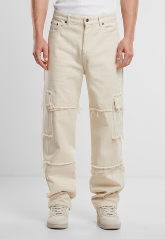 Karl Kani Baggy Cargo Pants in Beige: front