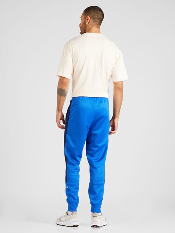 Regular Pantaloni sport 'AIR' de la Nike Sportswear pe albastru