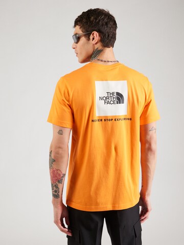 oranžinė THE NORTH FACE Marškinėliai 'REDBOX': priekis