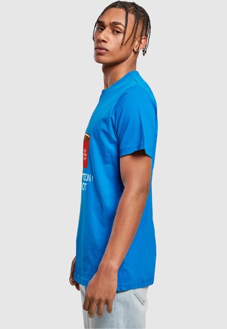T-Shirt 'Caution Hot' Merchcode en bleu