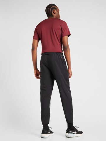 NIKE Zwężany krój Spodnie sportowe 'FLSH CHALLENGER' w kolorze czarny