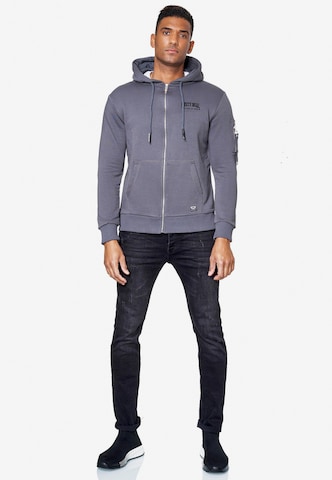 Rusty Neal Zip-Up Hoodie in Grey