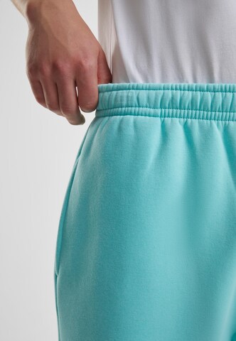 Tapered Pantaloni di Urban Classics in blu