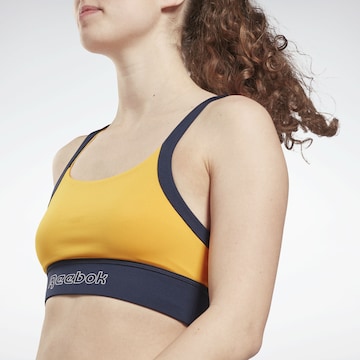 Reebok Bustier Športni nederček | oranžna barva