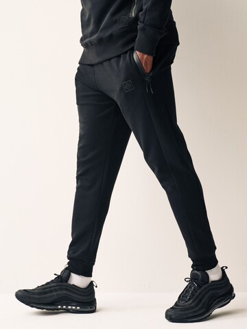 Tapered Pantaloni funzionali di Next in nero