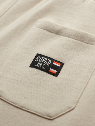 bēšs Superdry & Co Pakapēniski sašaurināts piegriezums Bikses 'ESSENTIAL'
