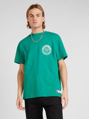 Tommy Jeans T-shirt 'ARCHIVE GAMES' i grön: framsida