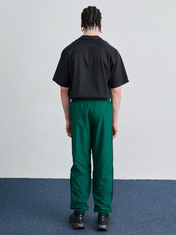 ADIDAS ORIGINALS Tapered Trousers in Green