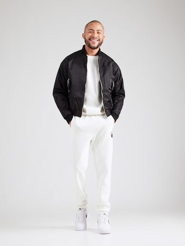 Tapered Pantaloni di Champion Authentic Athletic Apparel in bianco