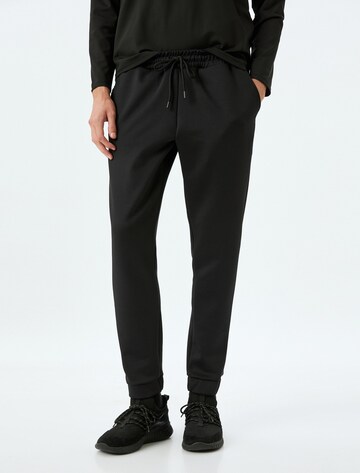 Koton Tapered Pants in Black: front