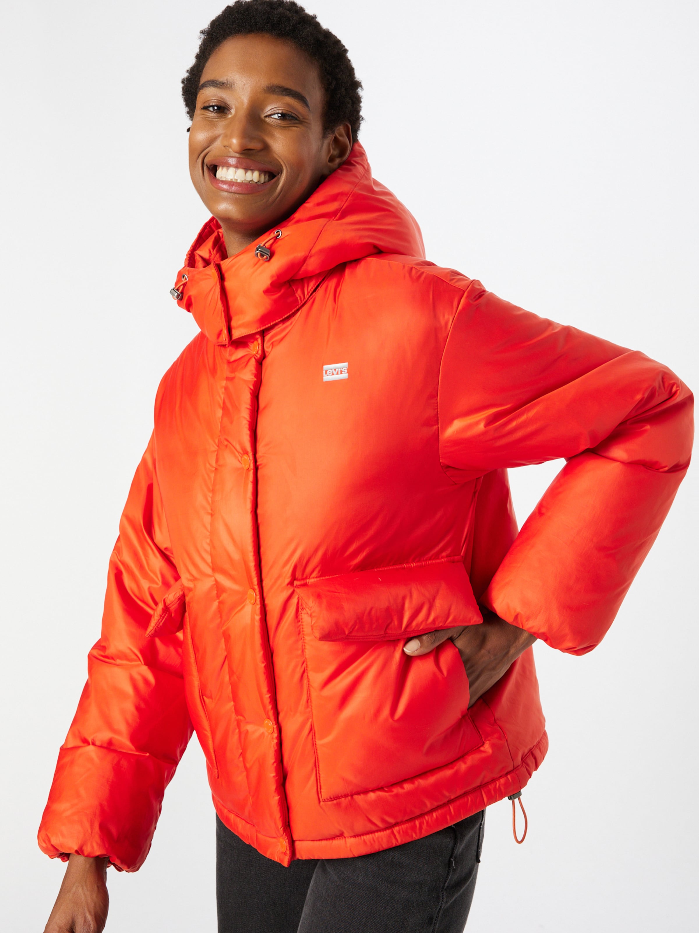 LEVI'S Winter Jacket 'CORE PUFFER SHORTY YELLOWS/ORANGES' in Lobster |  ABOUT YOU
