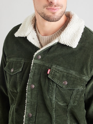 LEVI'S ® Демисезонная куртка 'Relaxed Fit Sherpa Trucker Jacket' в Зеленый