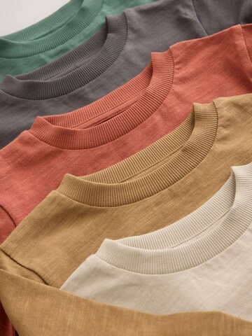 Tricou de la Next pe bej