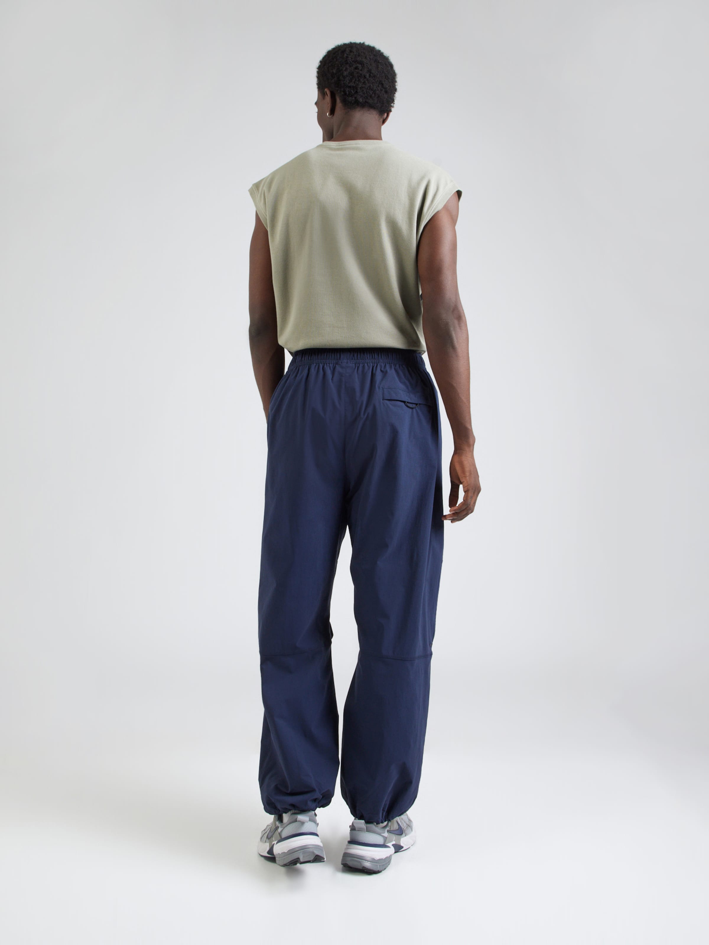Nike Sportswear Baggy Pantaloni 'Tech' pe Bleumarin | ABOUT YOU