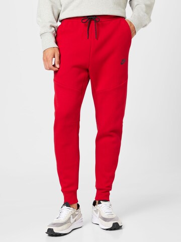 Nike Sportswear Tapered Trousers in Red: front