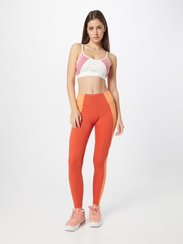 NIKE Skinny Spodnie sportowe w kolorze pomarańczowy