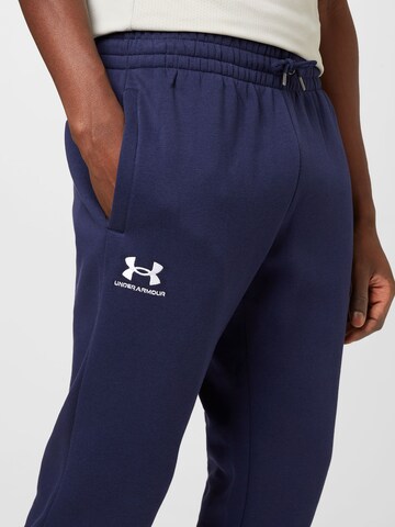 UNDER ARMOUR Tapered Urheiluhousut 'Essential' värissä sininen