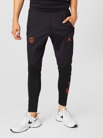 NIKE Tapered Workout Pants in Black: front