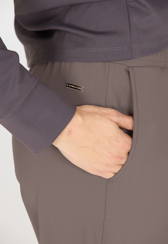 Athlecia Regular Sports trousers in Brown