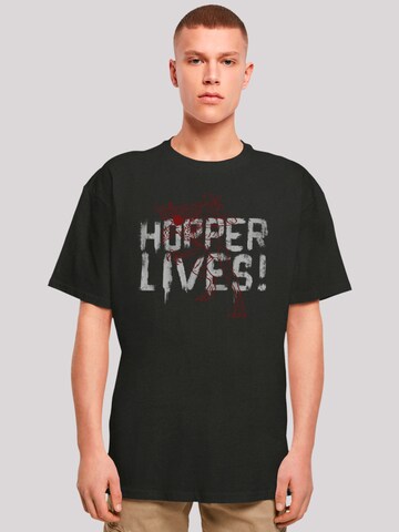 F4NT4STIC Shirt 'Stranger Things Hoppers Live Netflix TV Series' in Zwart: voorkant
