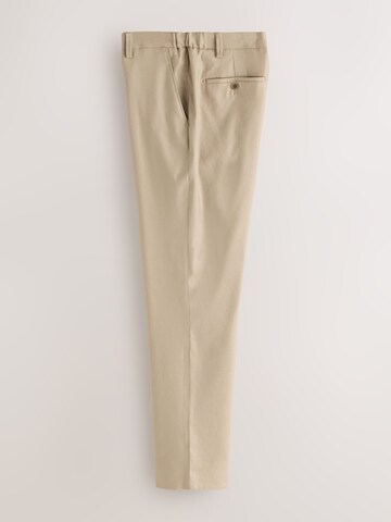 Coupe slim Pantalon à plis 'Motionflex' Next en gris