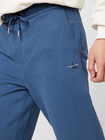 Calvin Klein Jeans Tapered Broek in Blauw