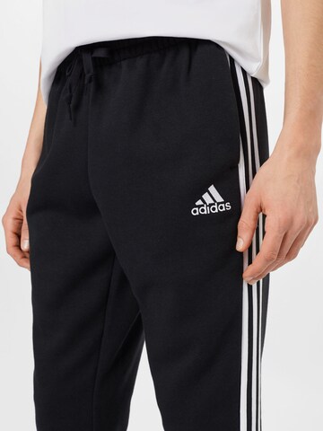 ADIDAS SPORTSWEAR Tapered Workout Pants 'Essentials Fleece Tapered Cuff 3-Stripes' in Black