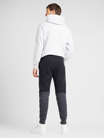 Nike Sportswear Zúžený Kalhoty 'TECH FLEECE' – černá