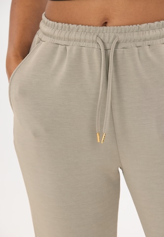 Athlecia Tapered Sports trousers 'Jacey' in Brown