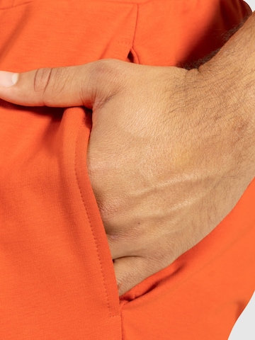 Effilé Pantalon de sport 'Nilo' Smilodox en orange