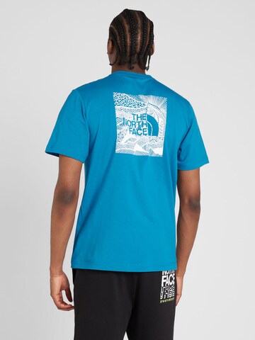 THE NORTH FACE - Camiseta 'REDBOX CELEBRATION' en azul: frente