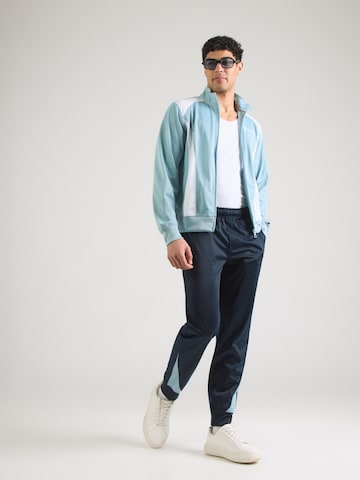 Champion Authentic Athletic Apparel Trainingspak in Blauw