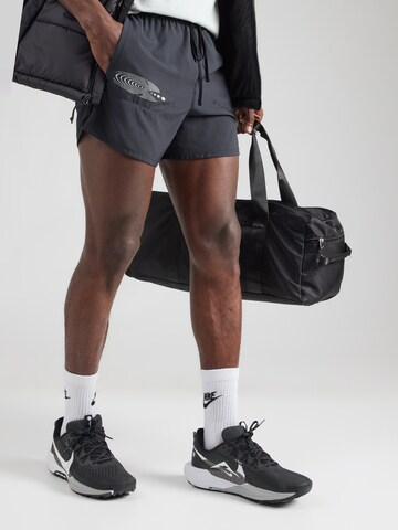 NIKE Regular Workout Pants 'STRIDE ENERGY' in Black: front