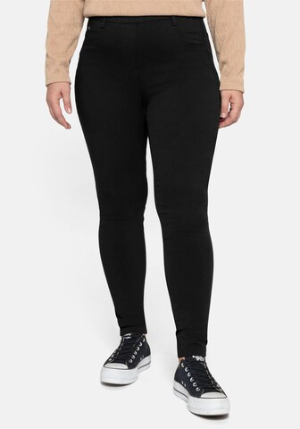 SHEEGO Skinny Pants in Black: front