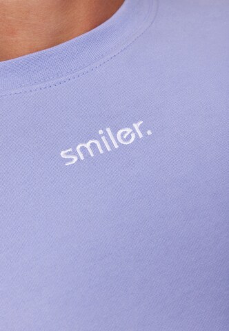 smiler. Shirt 'laugh.' in Lila
