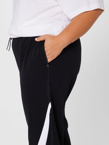 Nike Sportswear Tapered Workout Pants in Black